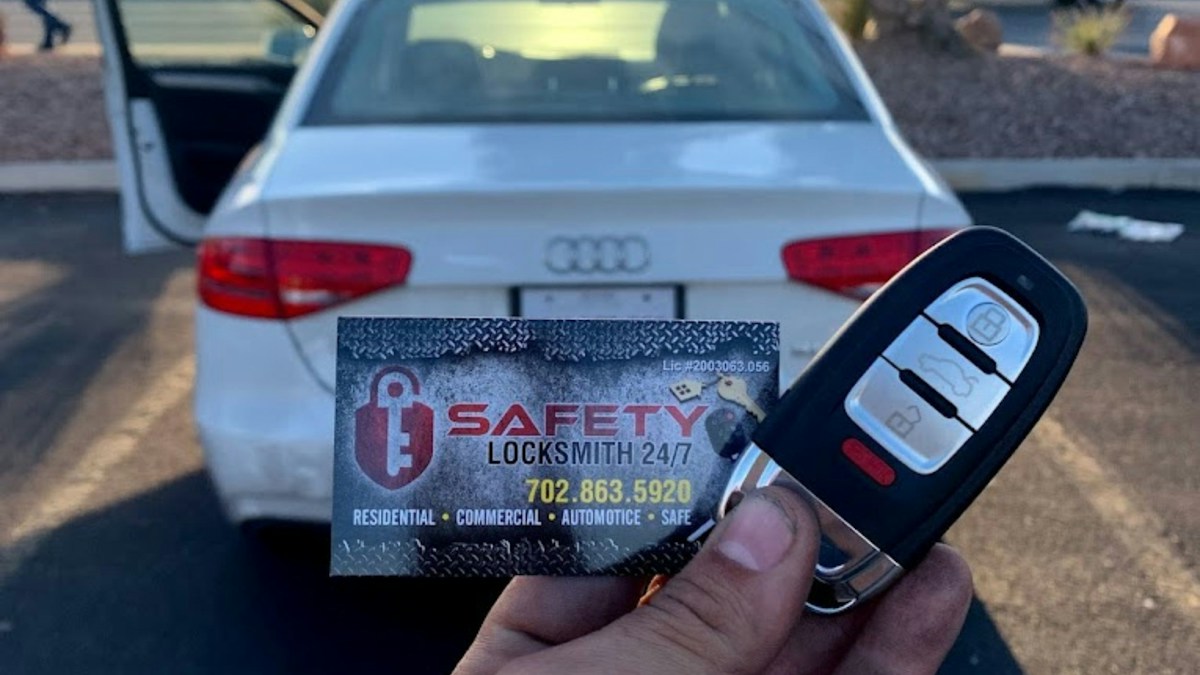 Car key held in front of a vehicle